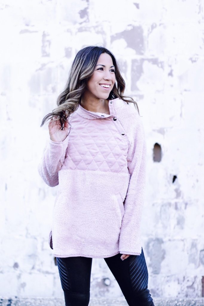 AFFORDABLE SWEATERS TO WEAR NOW FROM RED DRESS BOUTIQUE by top US fashion blog, House of Leo Blog: image of a woman wearing a pink fleece pullover from Red Dress Boutique and Spanx moto leggings
