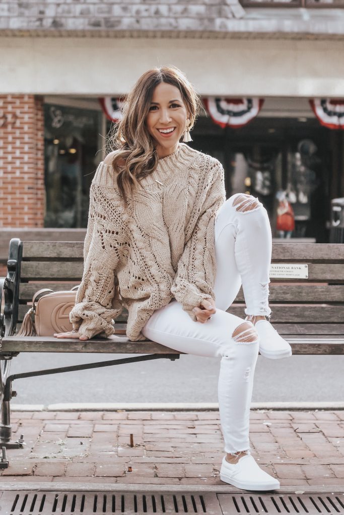 Early Spring Outfits featured by top US fashion blog House of Leo Blog; Image of a woman wearing Red Dress Boutique sweater, Vans sneaker, Buckle jeans, J. Bubs earrings and Nordstrom necklace.