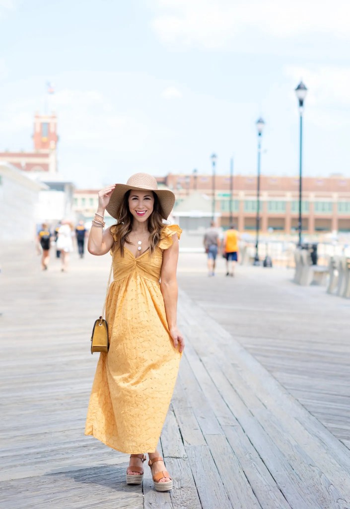 The 5 Summer Dress You Need by top US fashoin blog, House of Leo Blog: image of woman wearing yellow Embroidered Eyelet Maxi Dress, sam edelman Maura wedges and straw floppy hat