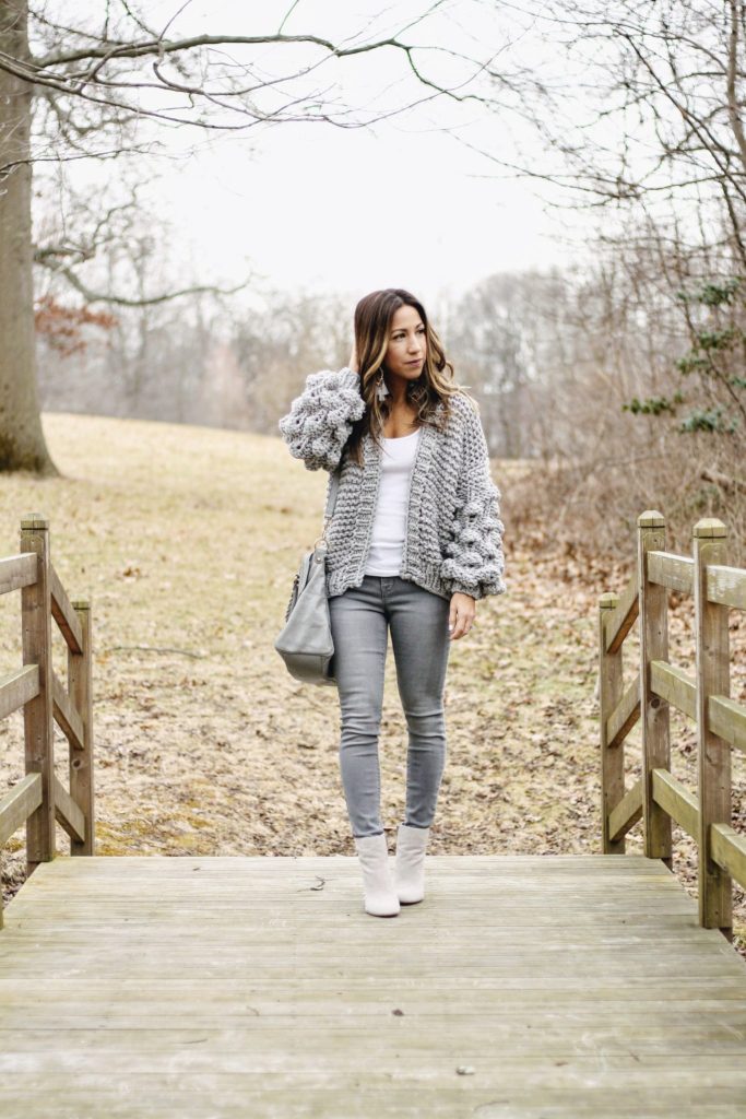 Old Navy Rockstar Jeans review featured by top New Jersey fashion blog, House of Leo: image of a woman wearing Old Navy Rockstar jeans, Goodnight Macaron chunky cardigan, Steve Madden ankle booties, Express tank top and BP earrings